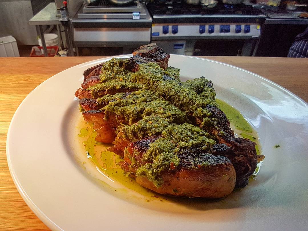 850g T-bone steak cooked over the coals. Garnished with a house made chimmi churri and served with a spelt and roast vegetable salad. Definitely a good one for sharing! ?: @sandy_mckay92 #tasmania #woodbridge #beef #tasmanianproduce #woodgrilled #cookingwithfire