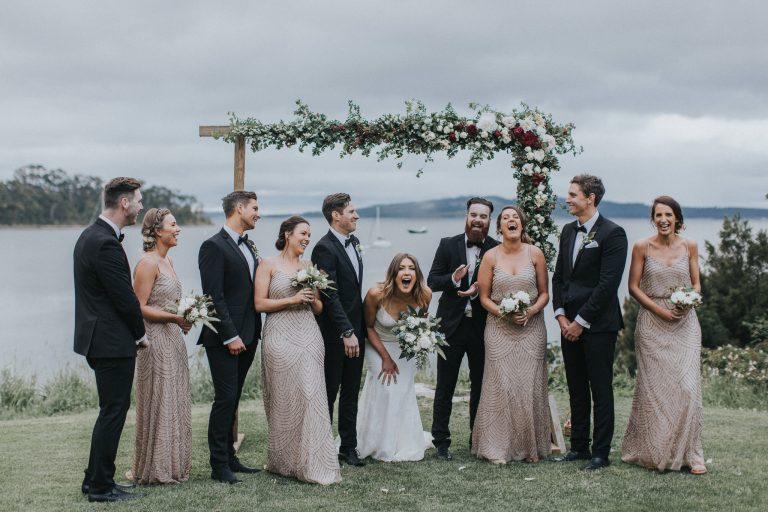 Bridal party laughing at the alter