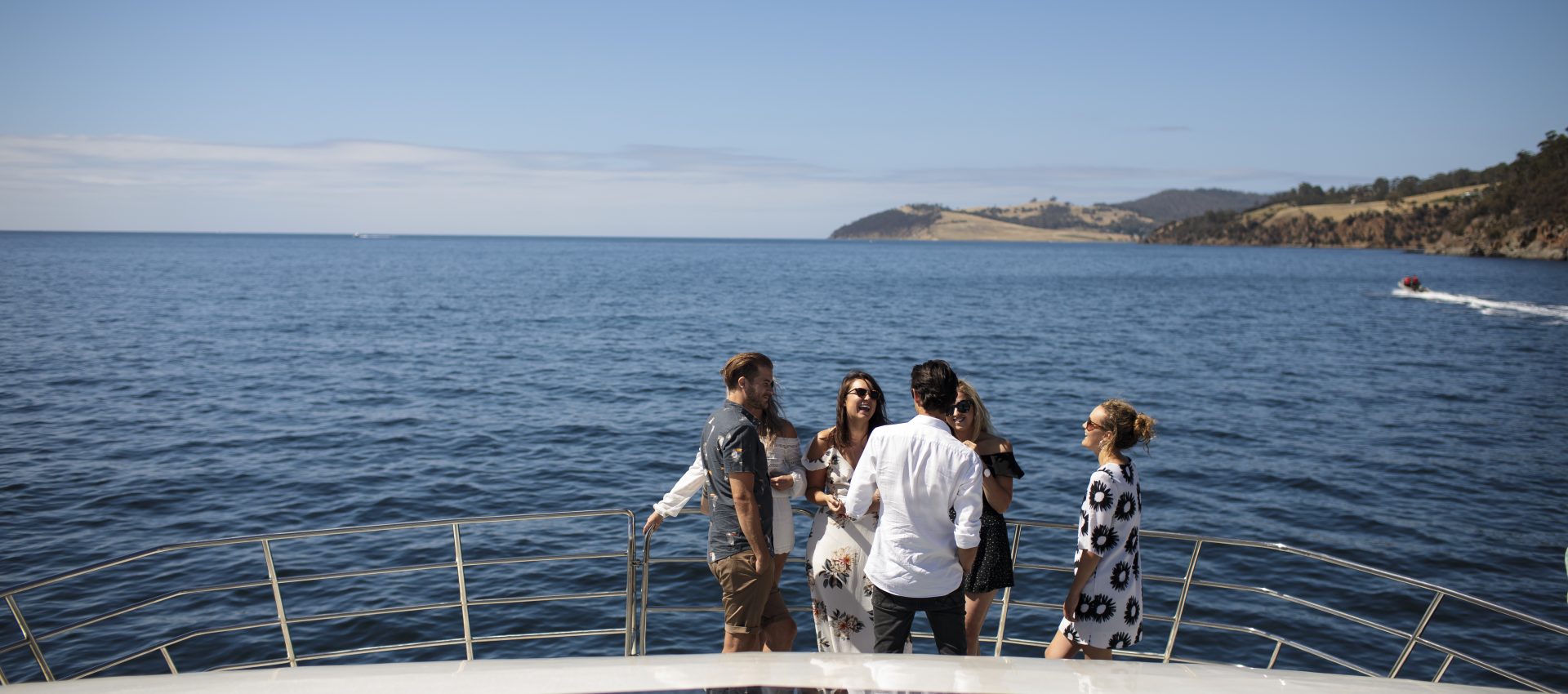 Group of people mingling on a catamaran