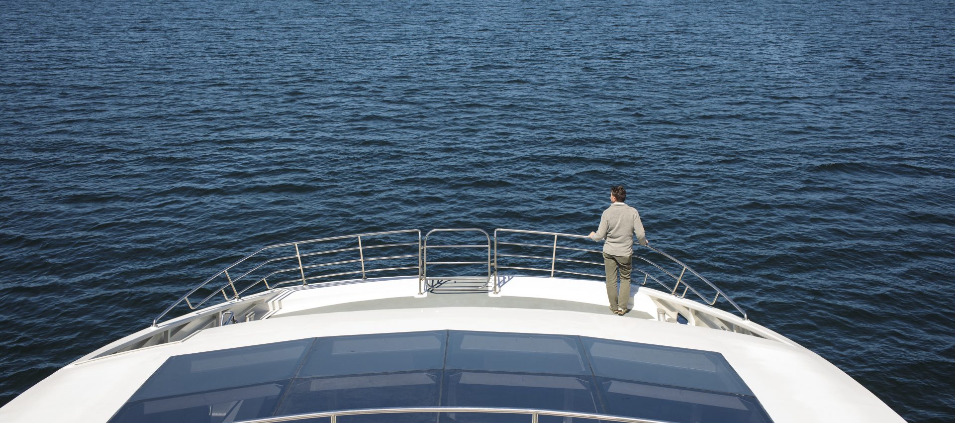 Man standing on the bow of a catamaran
