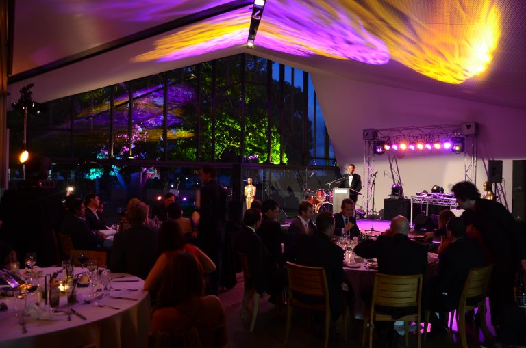 Guests sitting at round tables during a conference event